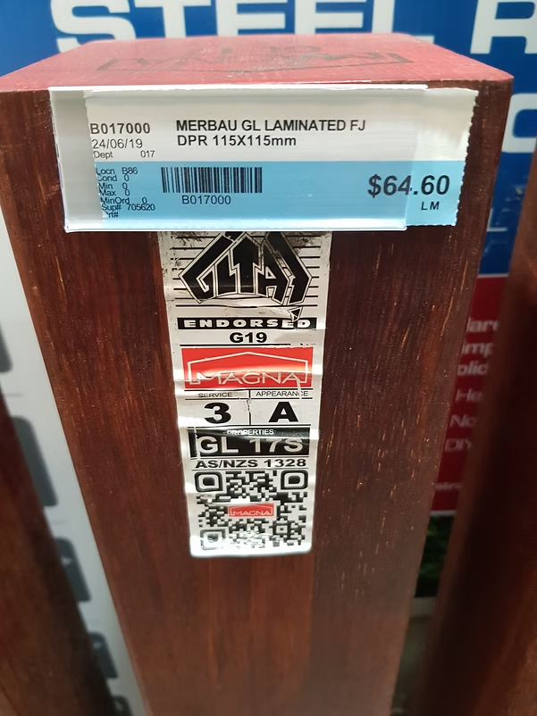 Laminated Merbau 115 by 115 mm post with its June 2019 price and product labels