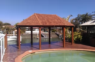 The same poolside gazebo with its new timber shingle roof