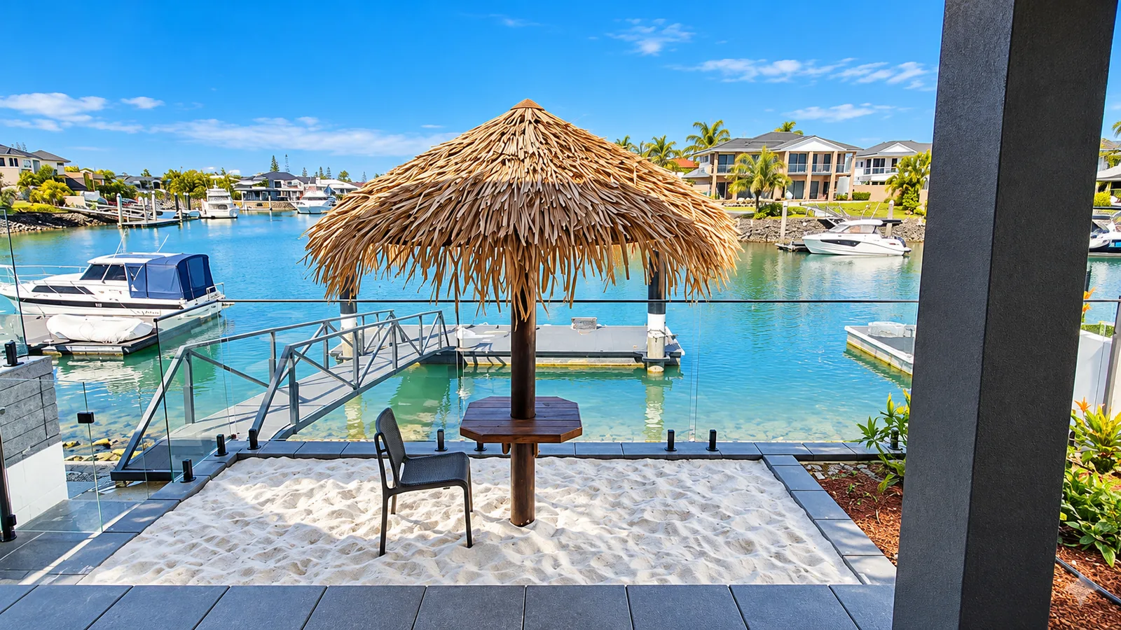 Synthetic thatch umbrella and table beside a waterfront